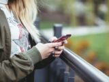 woman holding red phone