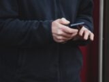 Person's hands holding a smartphone