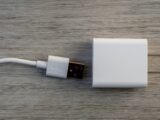 White usb charger and cable on wooden surface