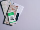 A health passport for COVID-19 displayed on a smartphone alongside travel documents.