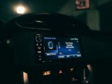 Close-up view of a car's dashboard at night displaying Bluetooth audio system.