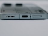 Detailed close-up of a smartphone's USB-C charging port and speaker grille, showcasing modern technology design.