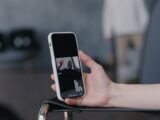Close-up of a smartphone held during a video call, capturing a friendly interaction.