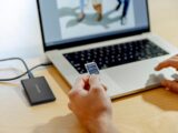A person sitting in front of a laptop computer