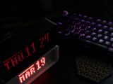 Digital clock displays date and time next to keyboard