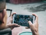 a man is playing a game on his phone