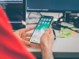 person using silver iPhone X
