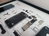 Disassembled smartphone components arranged on a diagram.