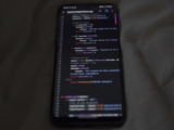 Close-up of a smartphone showing Python code on the display, showcasing coding and technology.