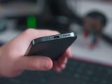 a close up of a person holding a cell phone