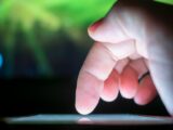 Close-up of a finger interacting with a touchscreen, capturing a moment of technology use.