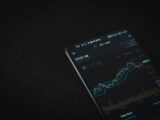 black android smartphone on black textile